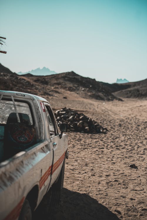 White Single Cab Pickup Truck on Dirt Road