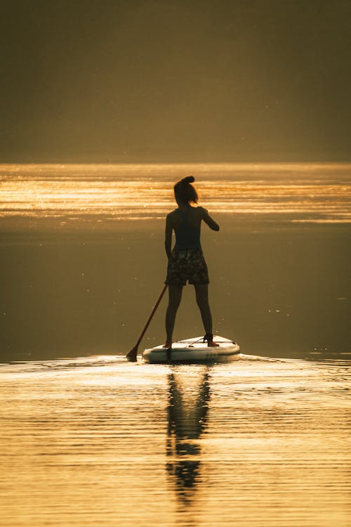 Tourist Standup Paddleboarding at Sunset