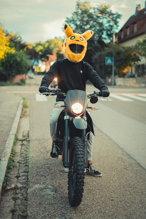 Man in a Pikachu Helmet Riding a Motocross