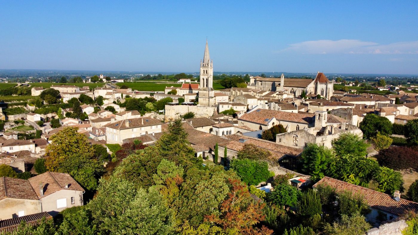 Aerial view of the town of Saint-Emilion in France with its Gothic church tower and surrounding vineyards