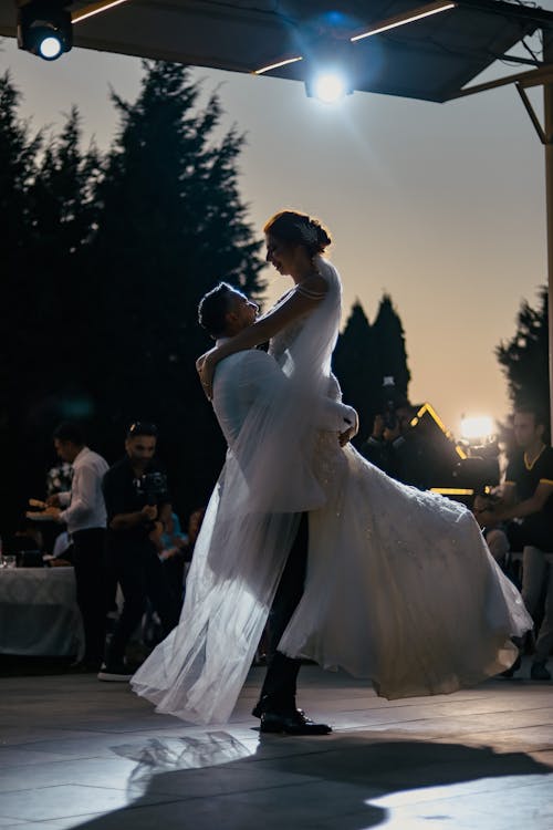Groom Holding Up Bride in Dance