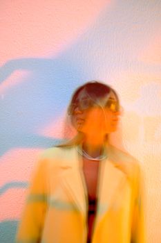 Colorful abstract portrait of woman in yellow blazer with motion blur.