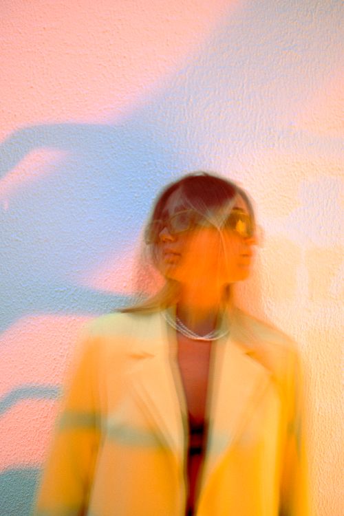 Free Colorful abstract portrait of woman in yellow blazer with motion blur. Stock Photo