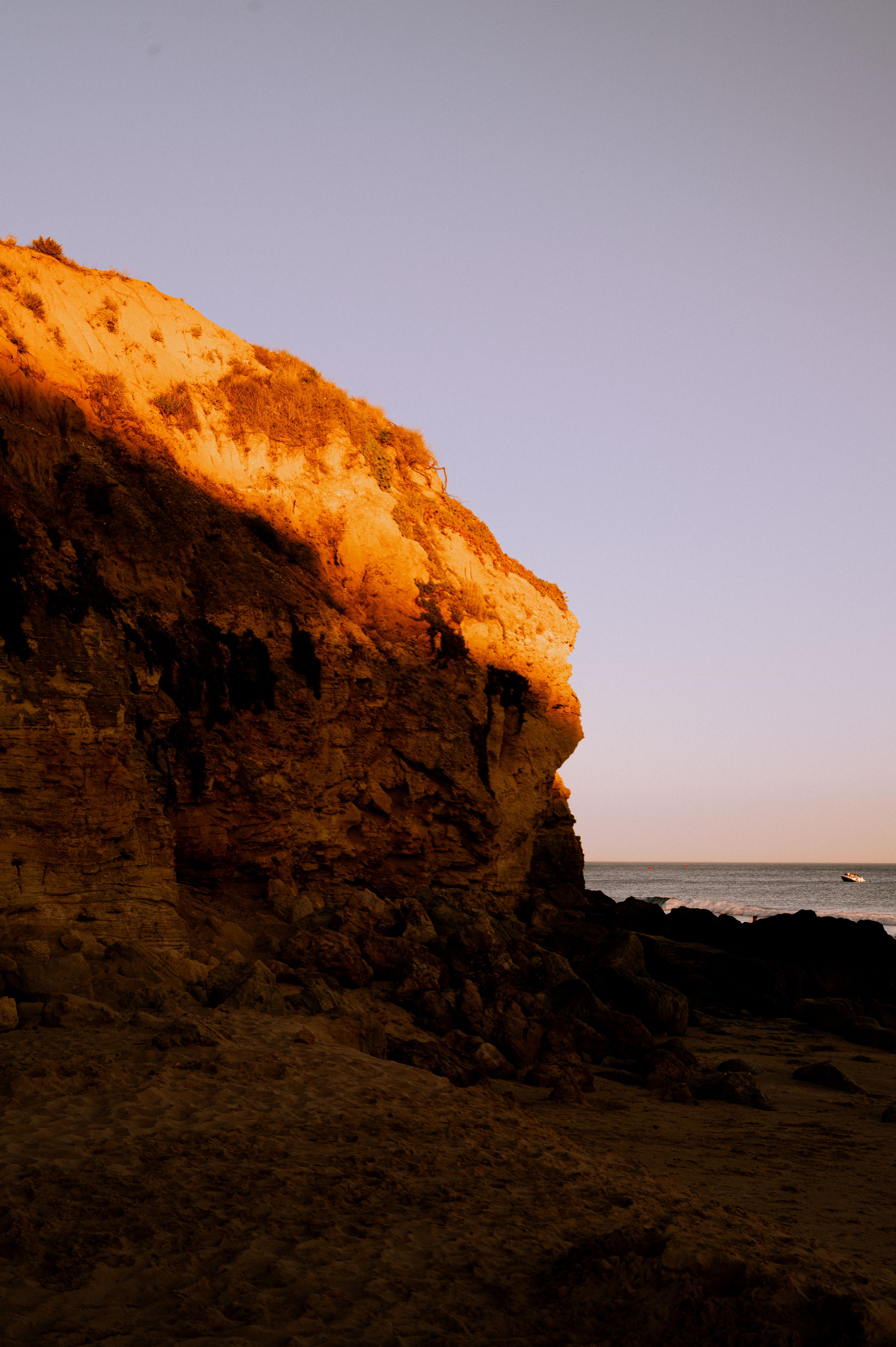 Seaside Cliff in the Light of the Rising Sun · Free Stock Photo