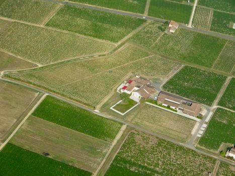 Aerial photo of a rural farm with surrounding fields and vineyard.
