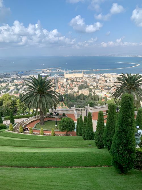 Free Breathtaking panorama of Bahá'í Gardens overlooking the Haifa skyline and coast. Stock Photo