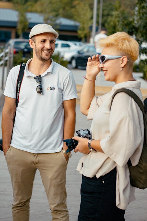 Man and Woman on a Street Holding a Camera