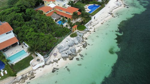 Houses with Swimming Pools on Tropical Sea Shore