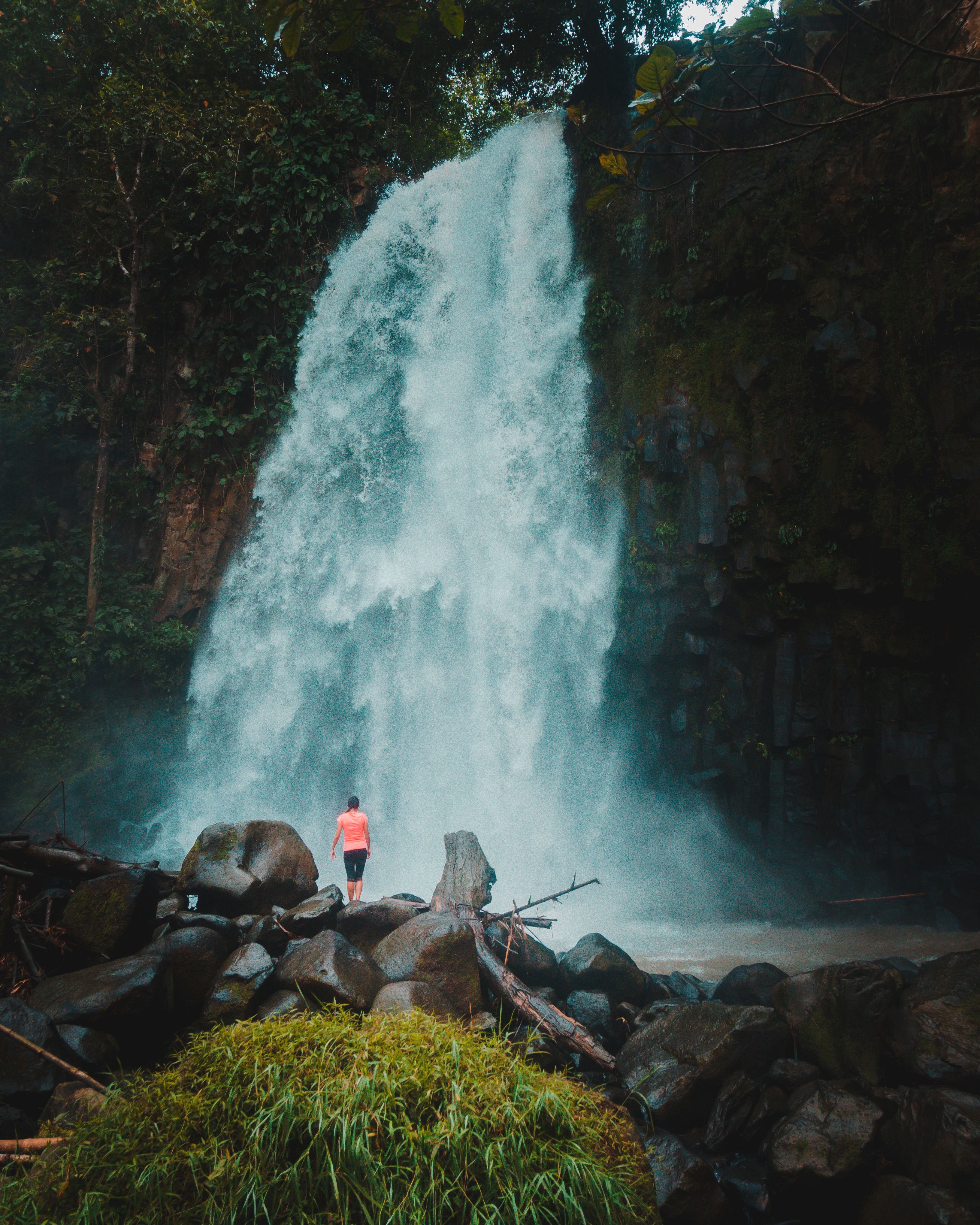 Woman in Bikini Standing on Rock Near Waterfall · Free Stock Photo