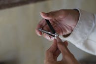 Close up of a man cutting his fingernail using nail clipper