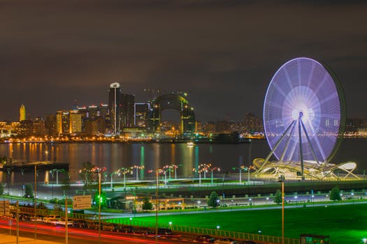 Stunning night cityscape of Baku featuring its iconic Ferris Wheel and modern skyline by the waterfront.