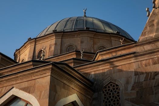 A striking view of a mosque dome under a clear blue sky in Baku, emphasizing architectural beauty.