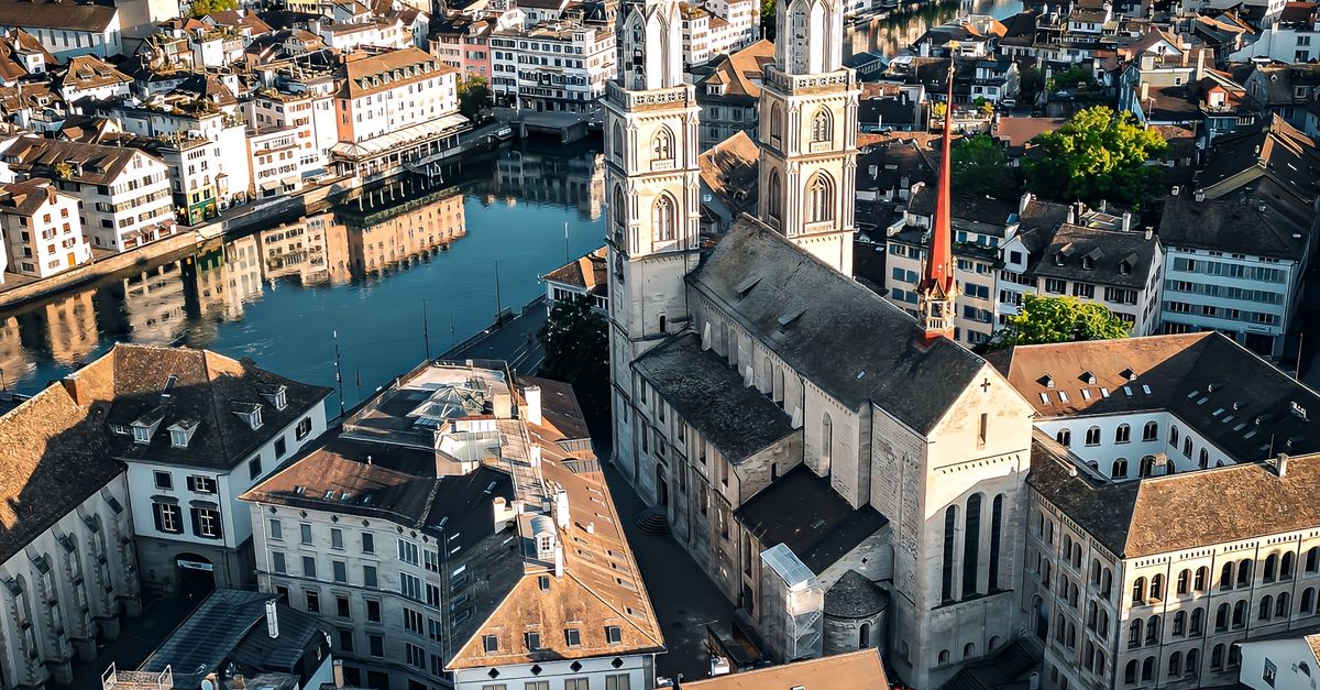 Stunning aerial shot of Zürich's cityscape highlighting the historic Grossmünster church.
