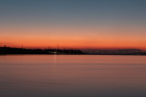 Free Stunning twilight view of Baku cityscape with Caspian Sea reflecting sunset hues. Stock Photo