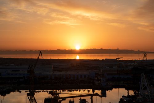 Free Beautiful sunset view over Baku harbor and Caspian Sea, capturing the urban silhouette. Stock Photo