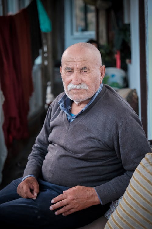 Bald Man with Moustache Sitting