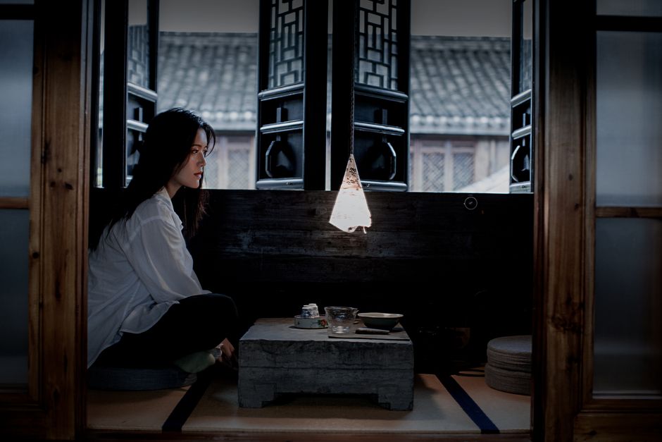 woman meditating tea ceremony calm room