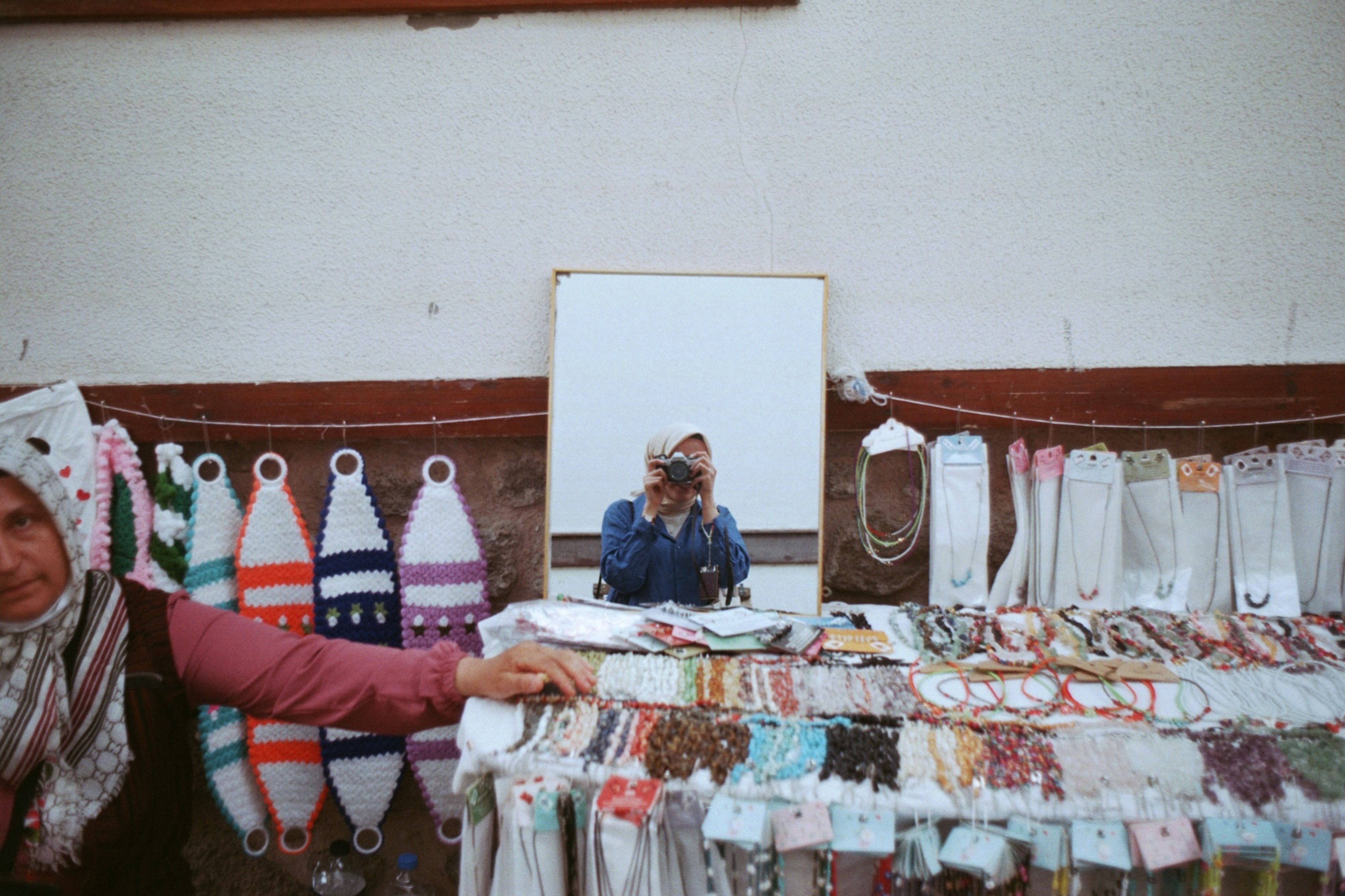 Woman in Hijab Taking Pictures in Mirror on Bazaar · Free Stock Photo