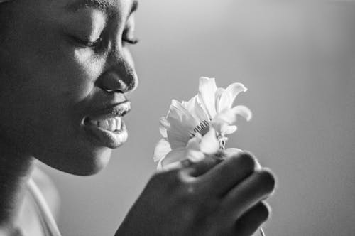 Woman Holding Flower in Black and White