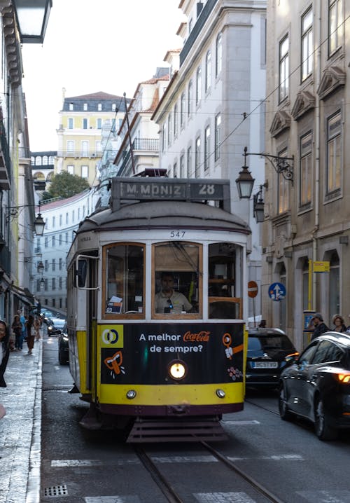 Old Train Running on Street in Lisbon
