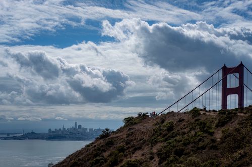Free Captivating view of San Francisco skyline with iconic Golden Gate Bridge and dramatic clouds. Stock Photo