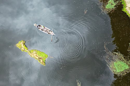 Aerial View of Boat in the Middle of Body of Water