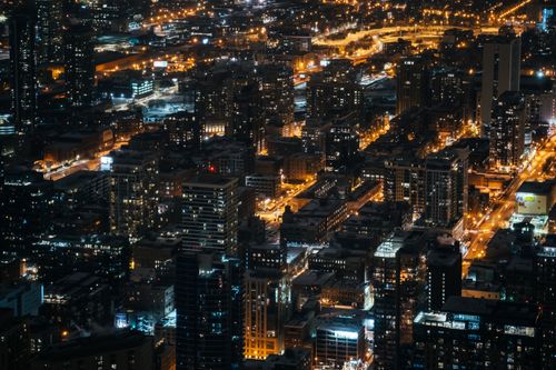 Free A breathtaking aerial shot capturing the vibrant cityscape and dazzling night lights of an urban downtown area. Stock Photo