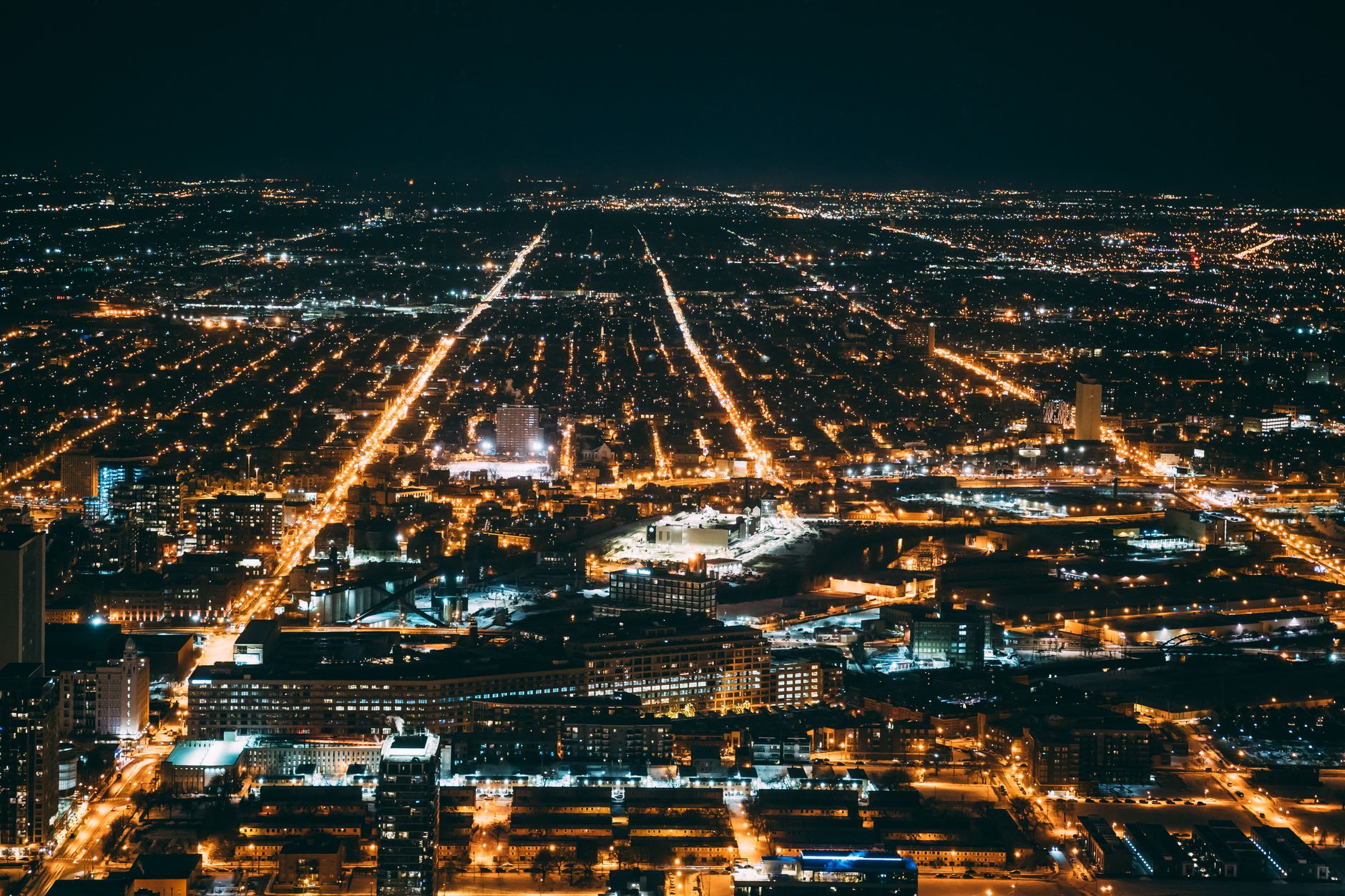 A breathtaking aerial view of a cityscape illuminated at night, showcasing urban beauty and vibrant city lights.