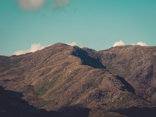 Free Explore this stunning aerial view of a rocky mountain landscape under a clear sky. Stock Photo