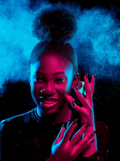 Dark Portrait of a Smiling Young Woman