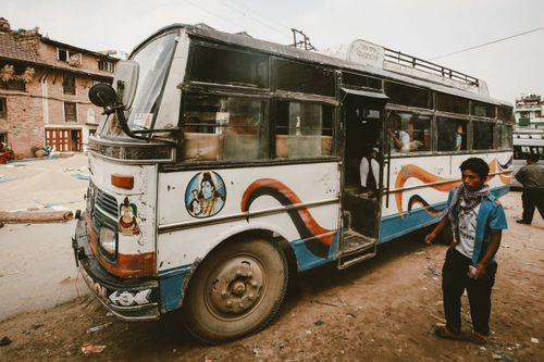 Free A colorful vintage bus on a bustling Indian street depicts urban life and travel. Stock Photo