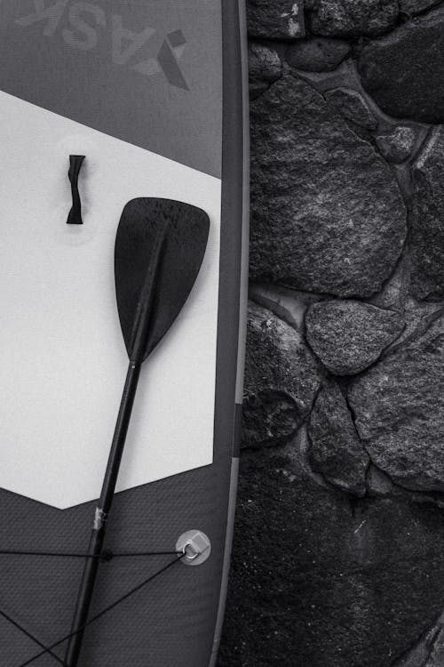 Surfboard Leaning Against a Stone Wall