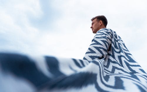 Man Wearing a Patterned Cloak