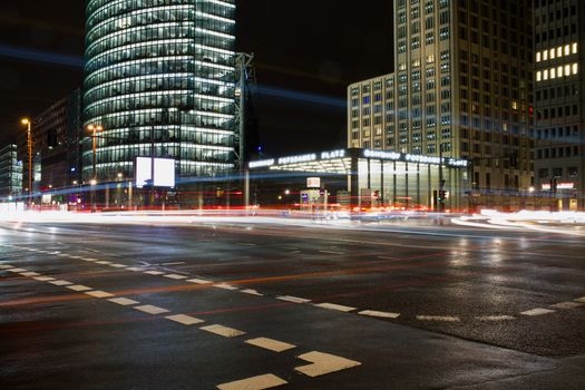 Long exposure captures traffic and modern architecture at Potsdamer Platz, Berlin by night.