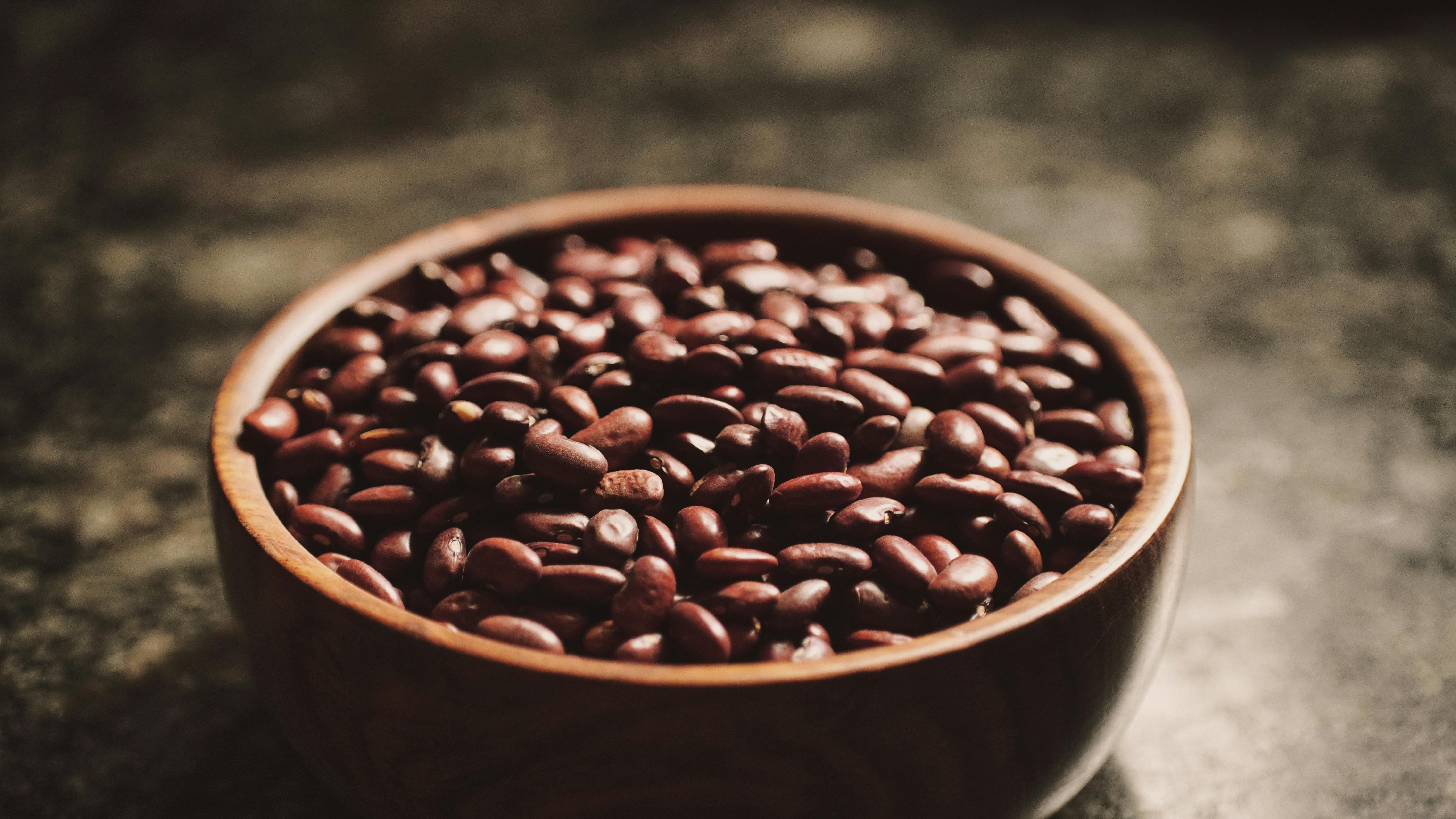 Wooden Bowl of Brown Kidney Beans on a Table