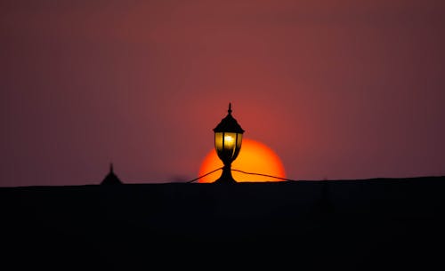 Beautiful sunset along with a lamp