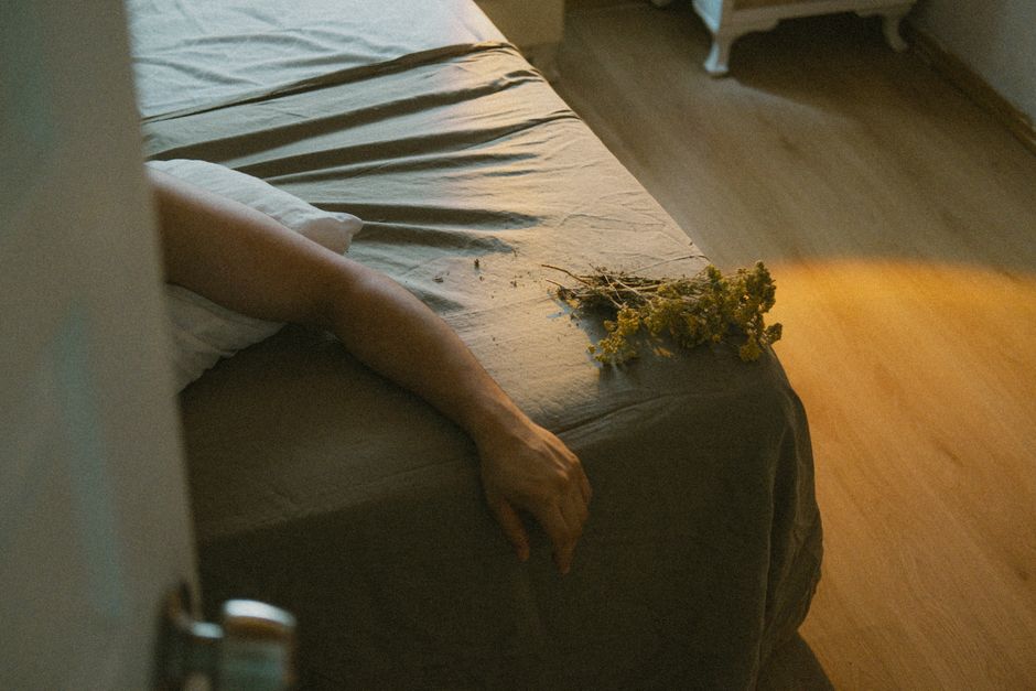 person lying relaxed bed evening light
