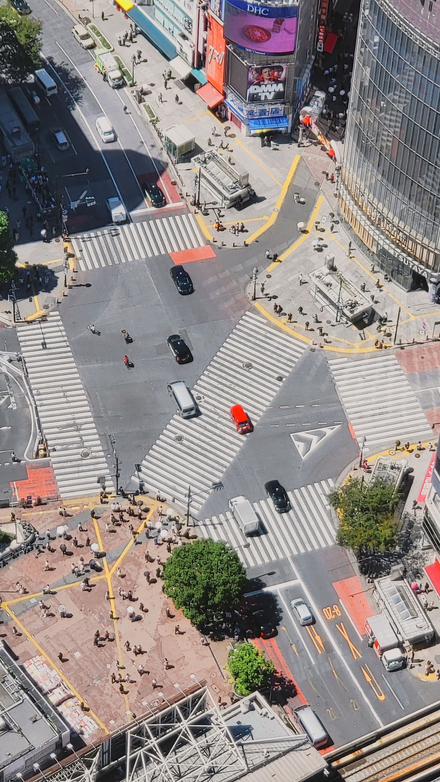 Aerial view of Shibuya Crossing in Tokyo with crowds of pedestrians and traffic