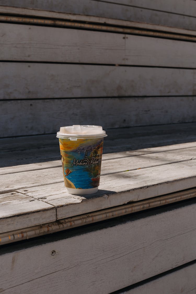 Takeout Cup Left On Wooden Bleachers