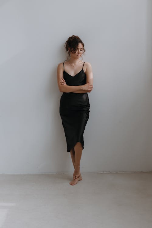 Barefoot Woman Standing in Black Spaghetti Straps Dress