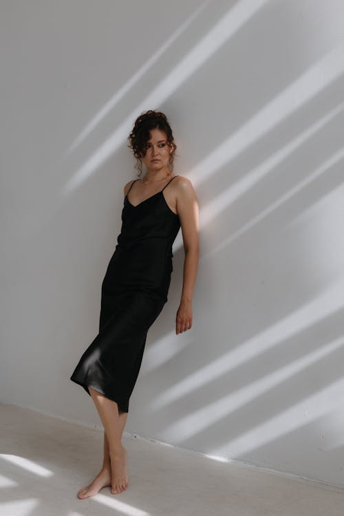Brunette Woman Posing in Black Midi Dress