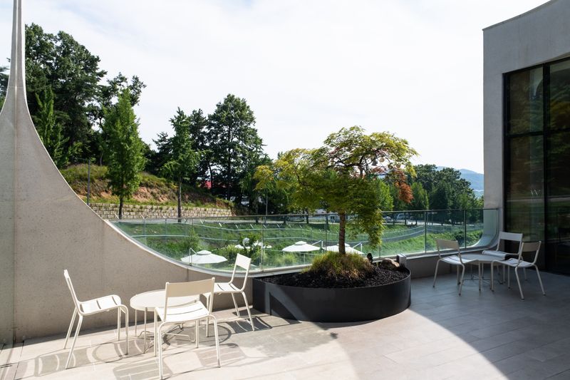Luxury outdoor terrace with modern furniture and garden views
