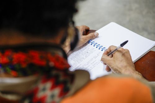 Free Close-up of a person writing in a spiral notebook with a ballpoint pen. Stock Photo