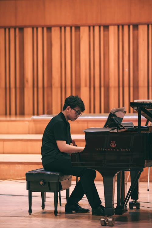 A Man Playing the Piano on Stage 