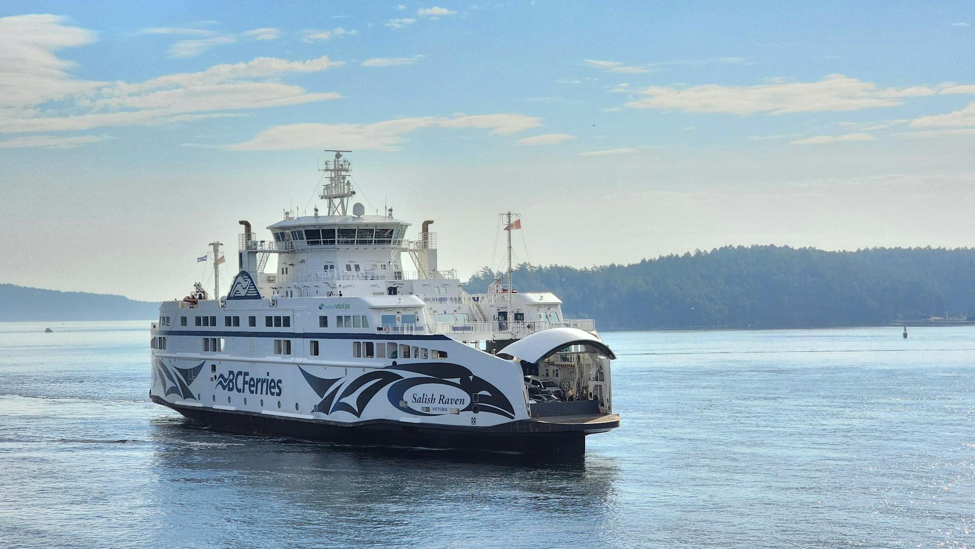 The BC Ferries Salish Raven ferry travels across the serene waters near North Saanich, BC, Canada.