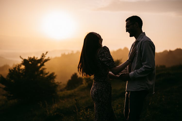 Silhouette Of Couple On A Field During Sunset