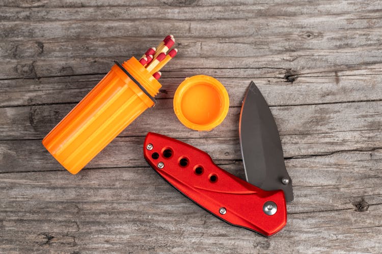 Knife And A Box Of Matches On A Wooden Board