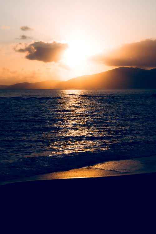 Free Captivating sunset view over the sea from Ajaccio, Corsica capturing tranquil waves and warm sunset hues. Stock Photo