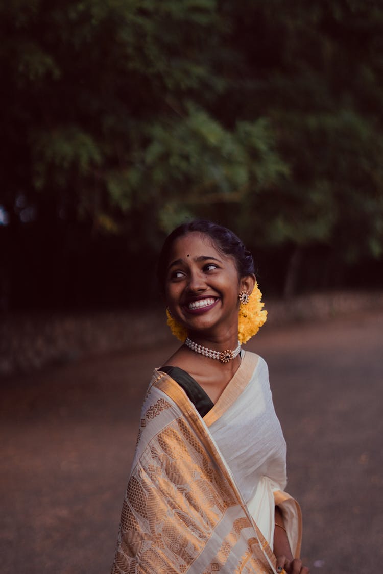 Portrait Of A Young Happy Brunette Woman In Traditional Indian Saree