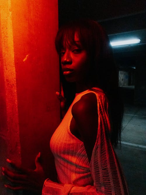 Model in a White Blouse in Red Lighting on Parking Garage